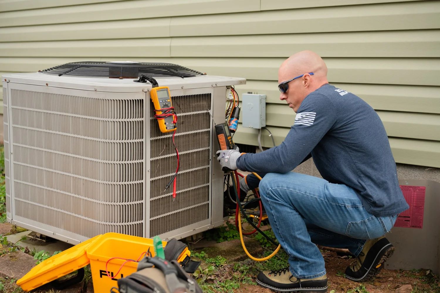 Air Force One technician testing a condenser with refrigerant gauges at a Northern Virginia home